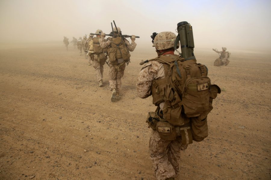 Marines with Weapons Company, 1st Battalion, 7th Marine Regiment, run to security positions after offloading from a CH-53E Super Sea Stallion helicopter during a mission in Helmand province, Afghanistan, April 28, 2014. The company's mission was to disrupt Taliban forces in Larr Village and establish a presence in the area. Five days prior to the helicopter-borne mission, the company confiscated two rocket-propelled grenades in the vicinity of the village.